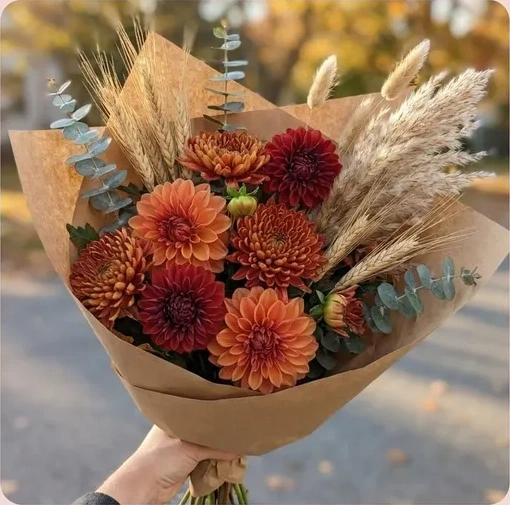 A bunch of autumn dahlias and dried grasses